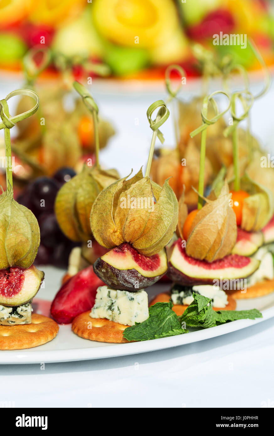 Canapes with physalis, fig, cheese and crackers Stock Photo