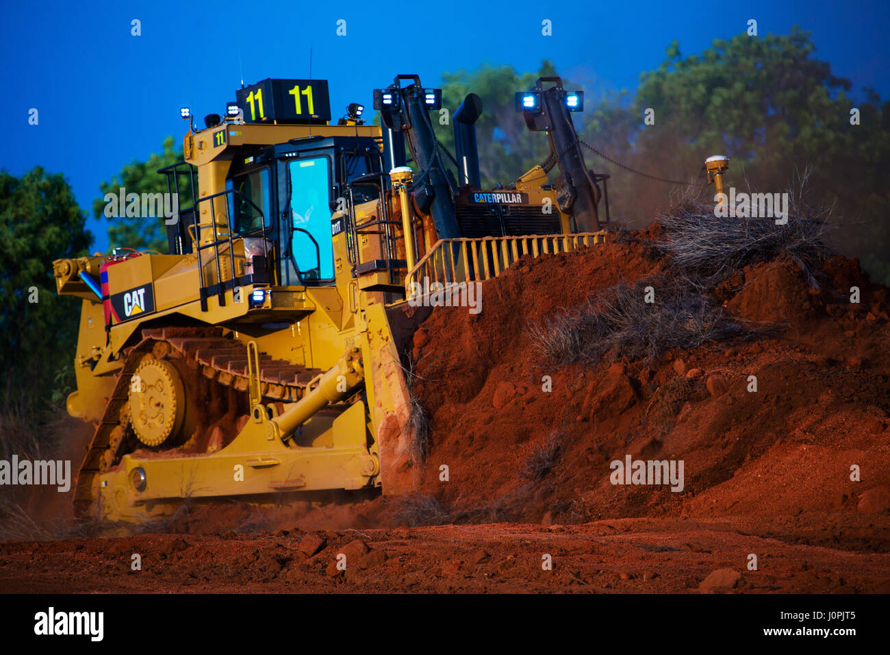 A huge bulldozer at work strip mining bauxite, Far North Queensland Stock Photo