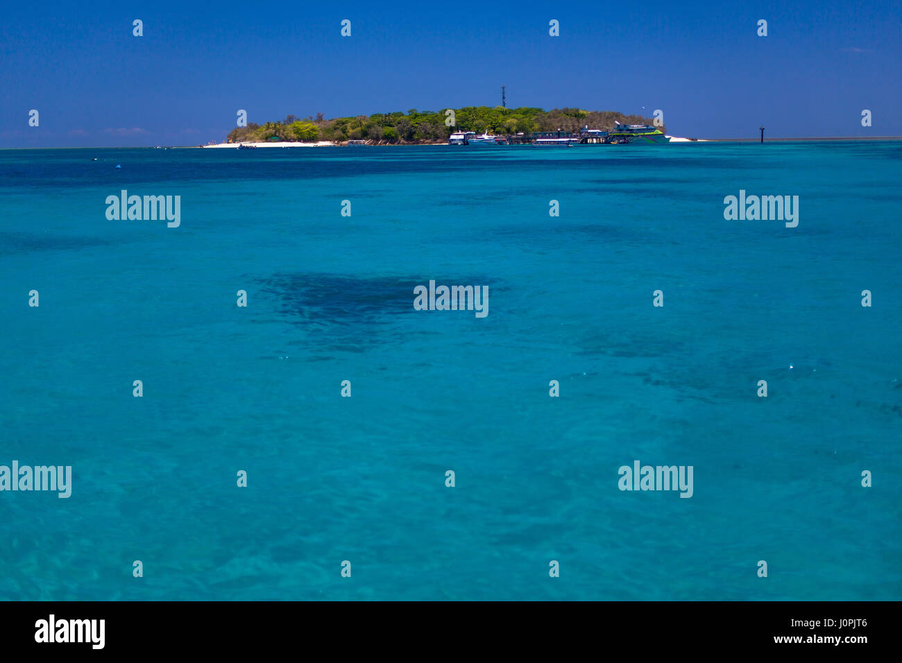 Green island resort seen from the turquoise Coral Sea and Great Barrier Reef. Stock Photo