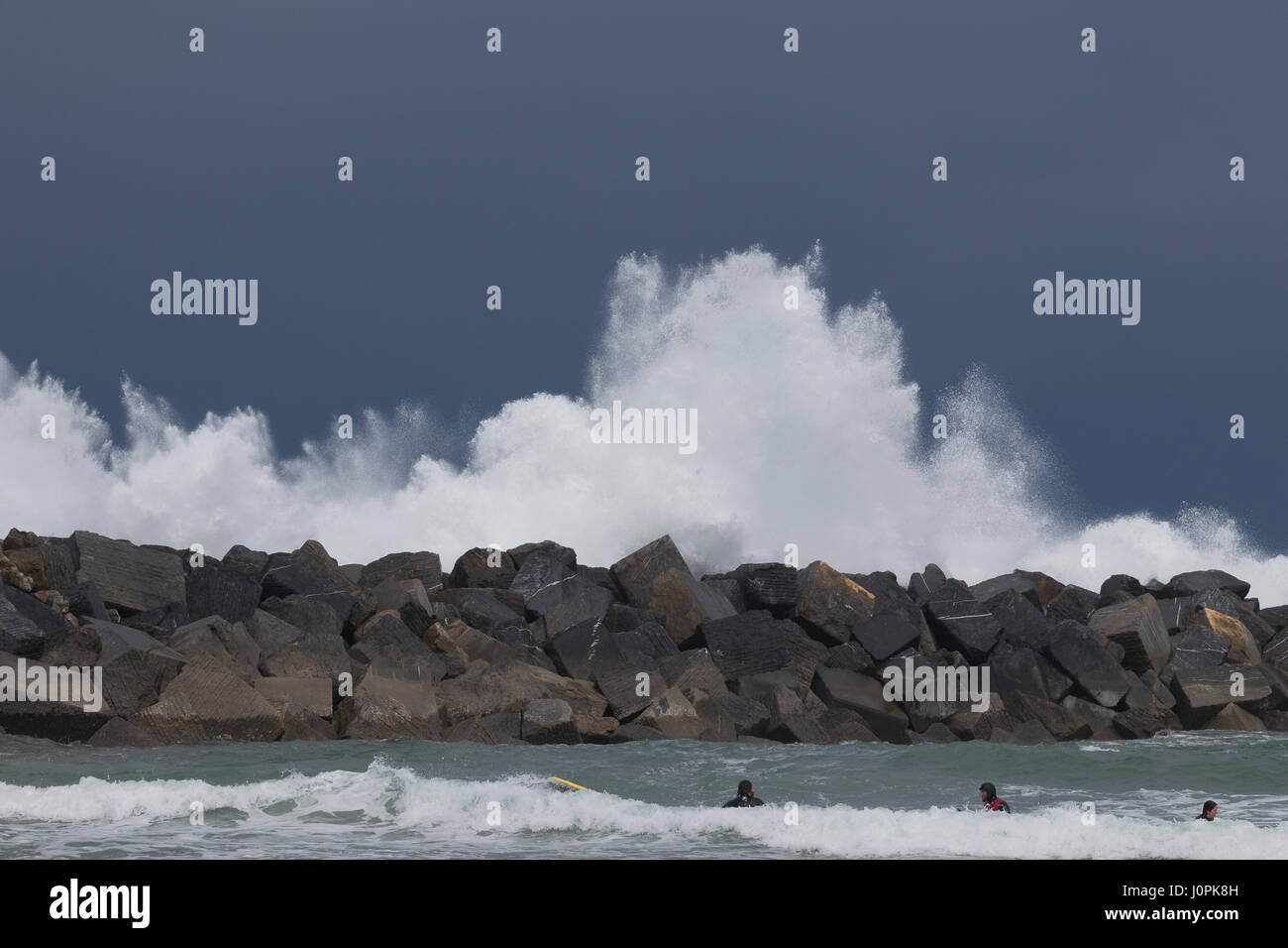 Waves breaking in a breakwater like an explosion in La Zurriola beach (San Sebastian, Spain) 2017. Stock Photo