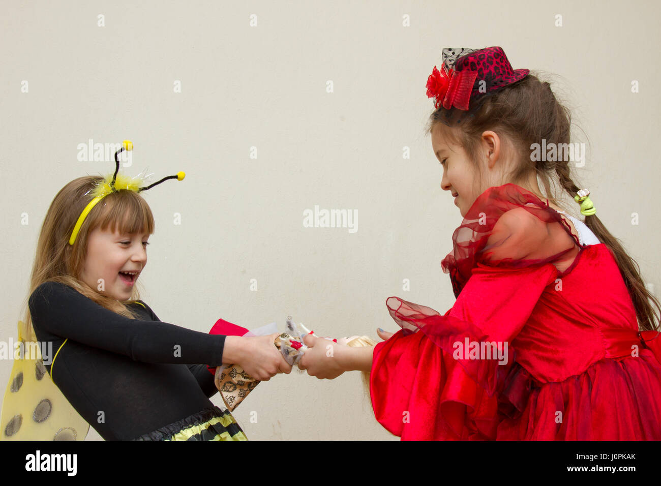 little girls fighting over a toy Stock Photo Alamy