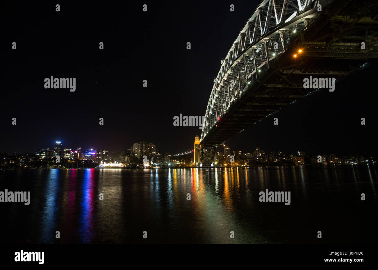 Sydney Harbour bridge reflects in the still waters at night Stock Photo