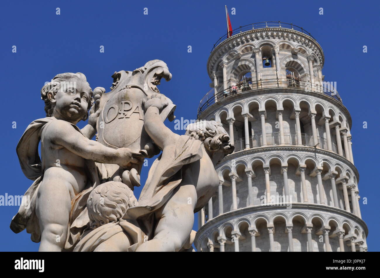 The Leaning Tower of Pisa or simply the Tower of Pisa is the campanile, or freestanding bell tower, of the cathedral of the Italian city of Pisa, know Stock Photo