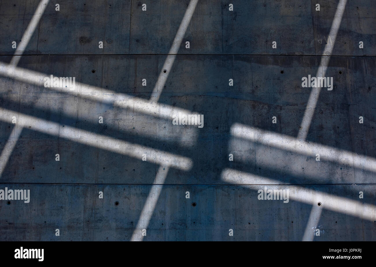 Light and shadow splay diagonal lines across the concrete column of the huge solar power structure in the FORUM, Barcelona, Spain Stock Photo
