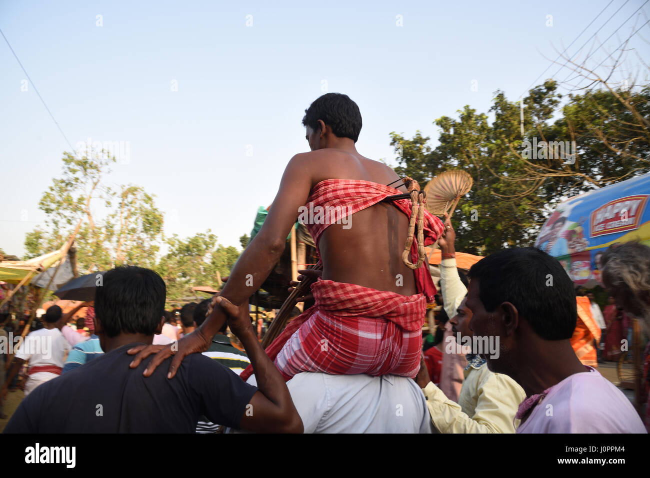 Devotees hooks pierced on back and hanging on the rope ritual performed  during Charak Puja Stock Photo - Alamy