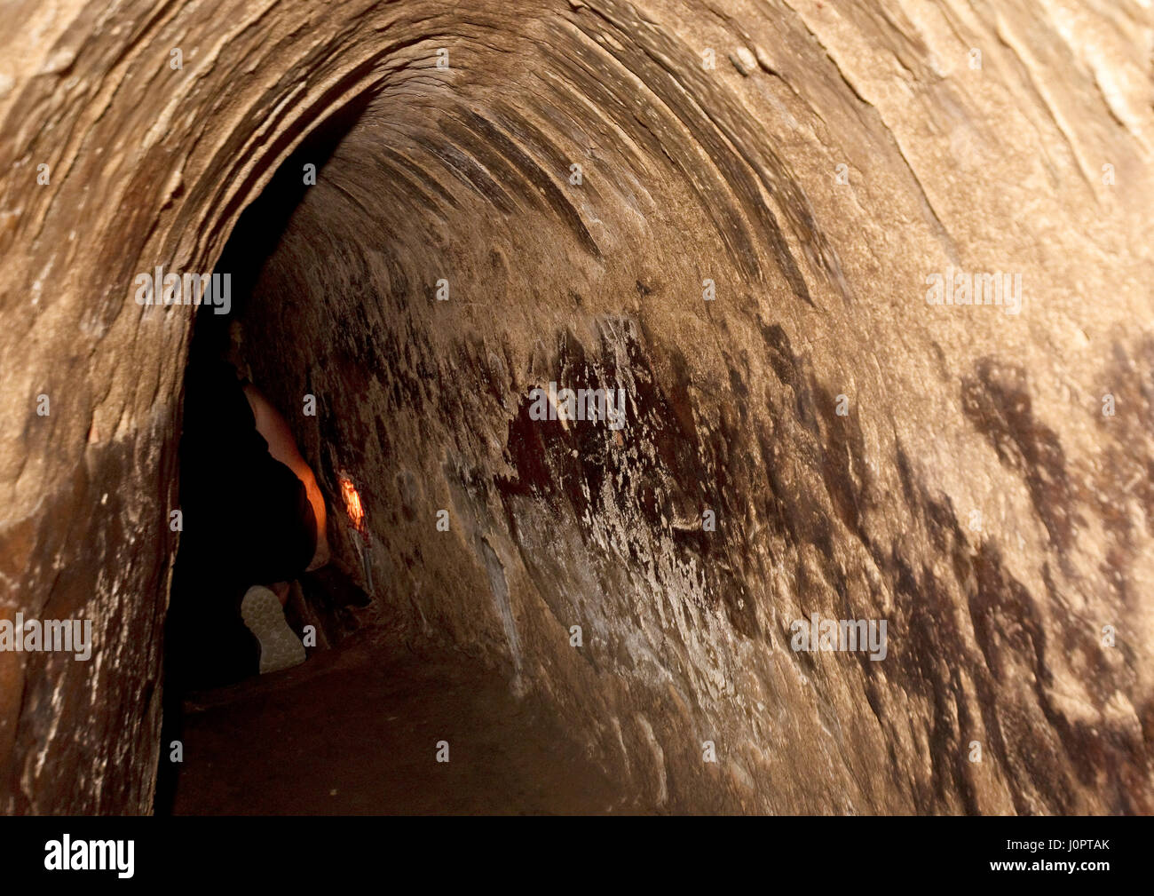 Crawling through Viet Cong tunnel at Cu Chi Stock Photo