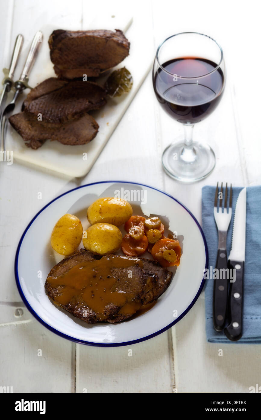 Classic one pan beef roast with baby potatoes and vegetables Stock Photo