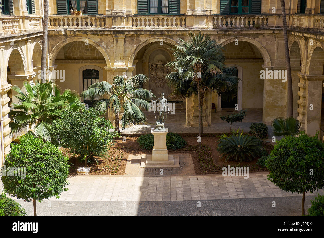 The view of Neptune Courtyard with statue of Neptun and a garden