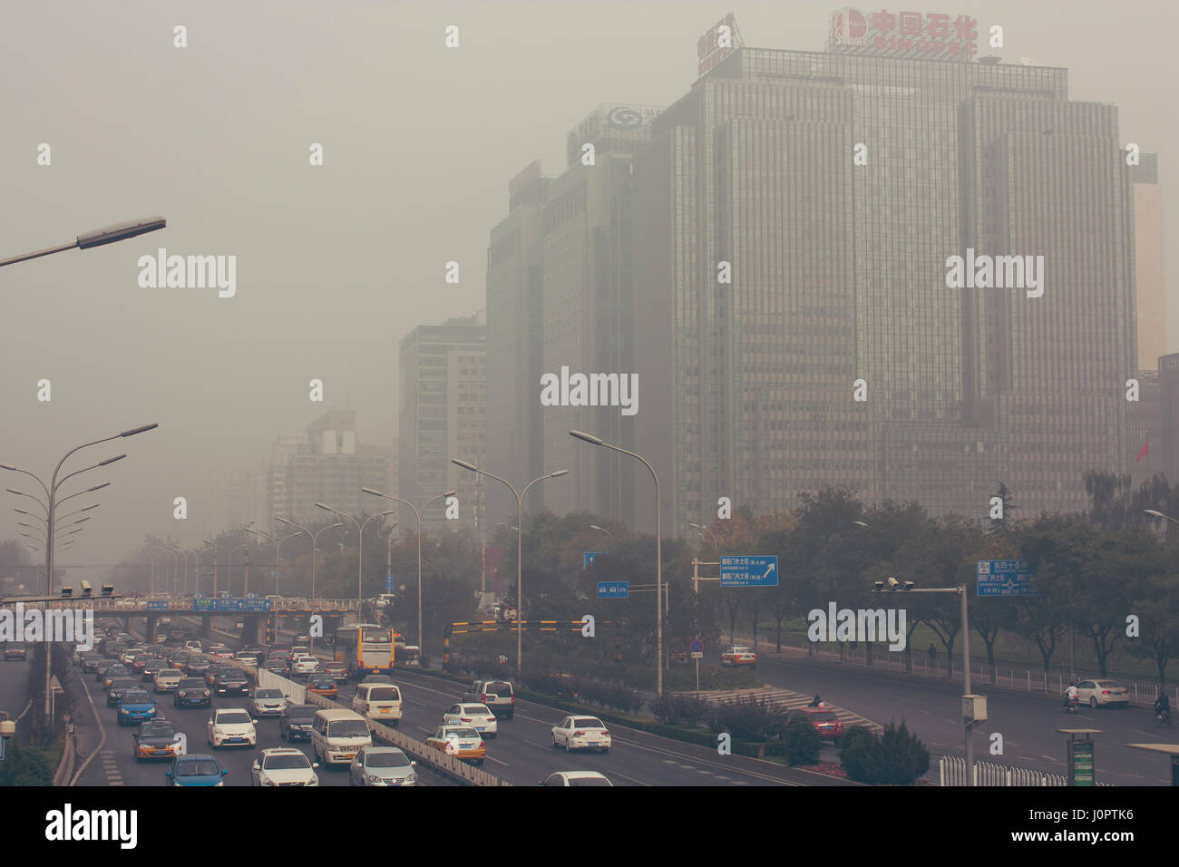 24 October,2014 - Beijing China. Air pollution in Beijing China city center,countless cars stuck on the road,the building beides are Sinopec(the China Stock Photo
