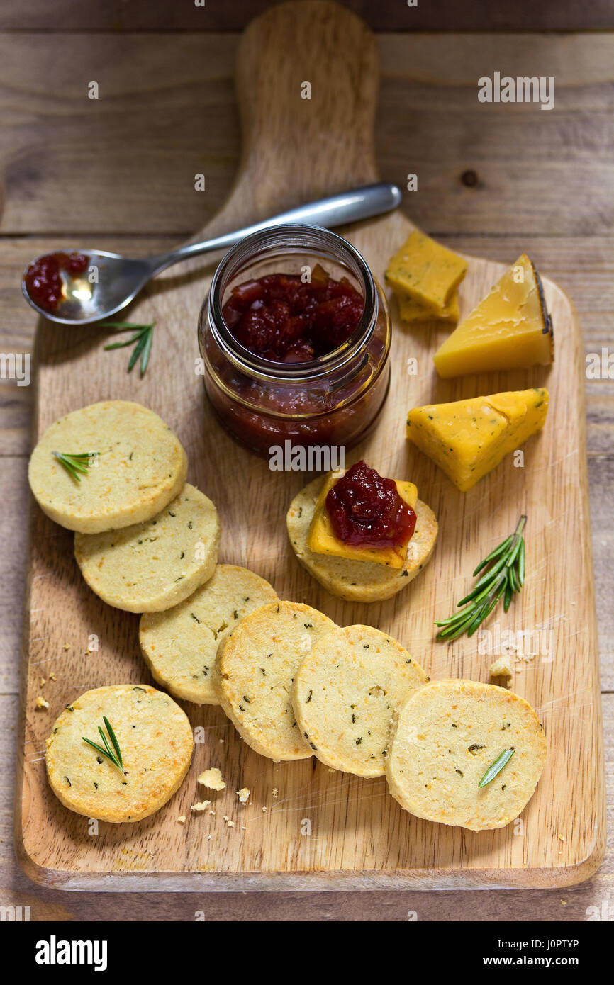Rosemary crackers on cheese board with relish Stock Photo Alamy