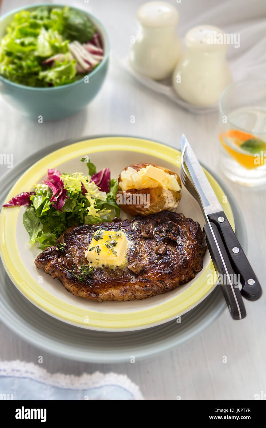 Steak with baked potato and salad Stock Photo - Alamy