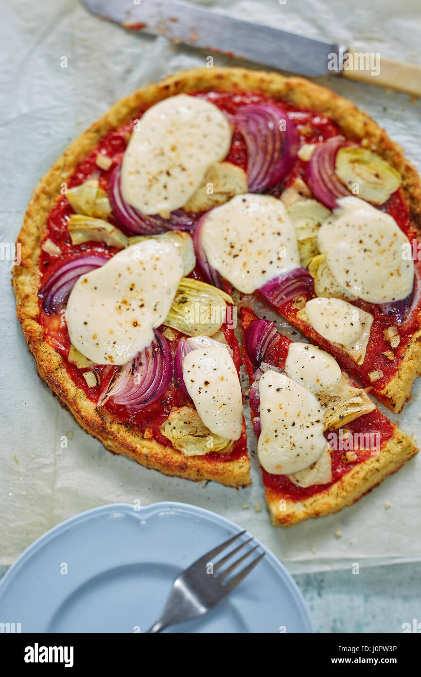 Vegie cauliflower pizza base with artichoke, red onion and mozzarella Stock Photo