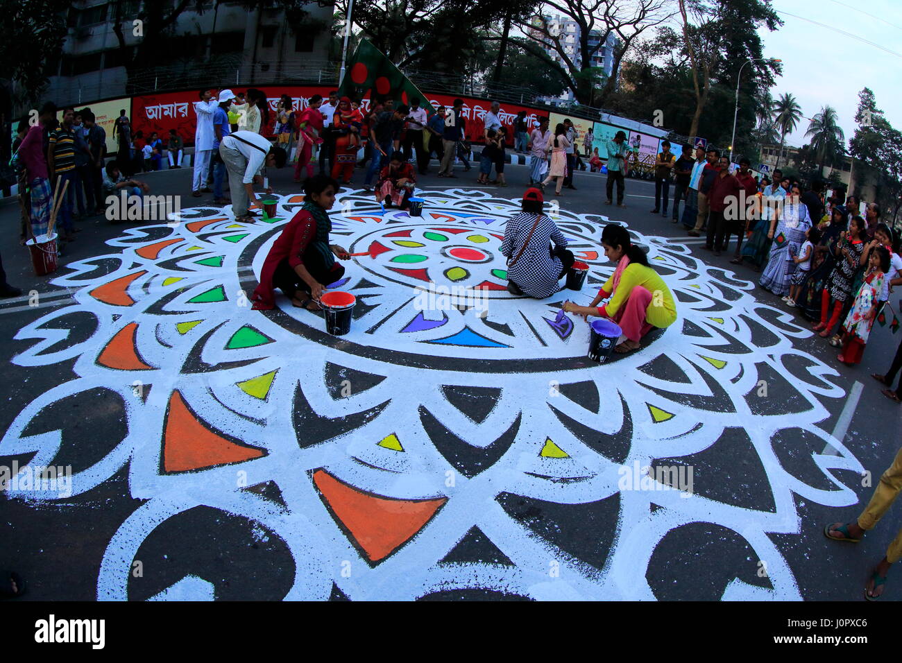 Students of Fine Art Institute of Dhaka University paint floral motifs on the road on occasion of the International Mother Language Day. Dhaka, Bangla Stock Photo