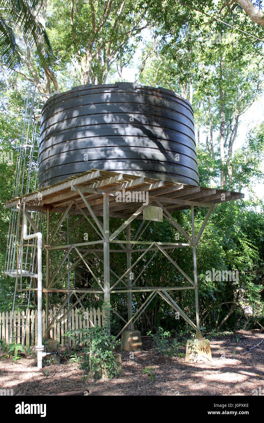 Old Water tank on elevated stand in rural area Australia Stock Photo