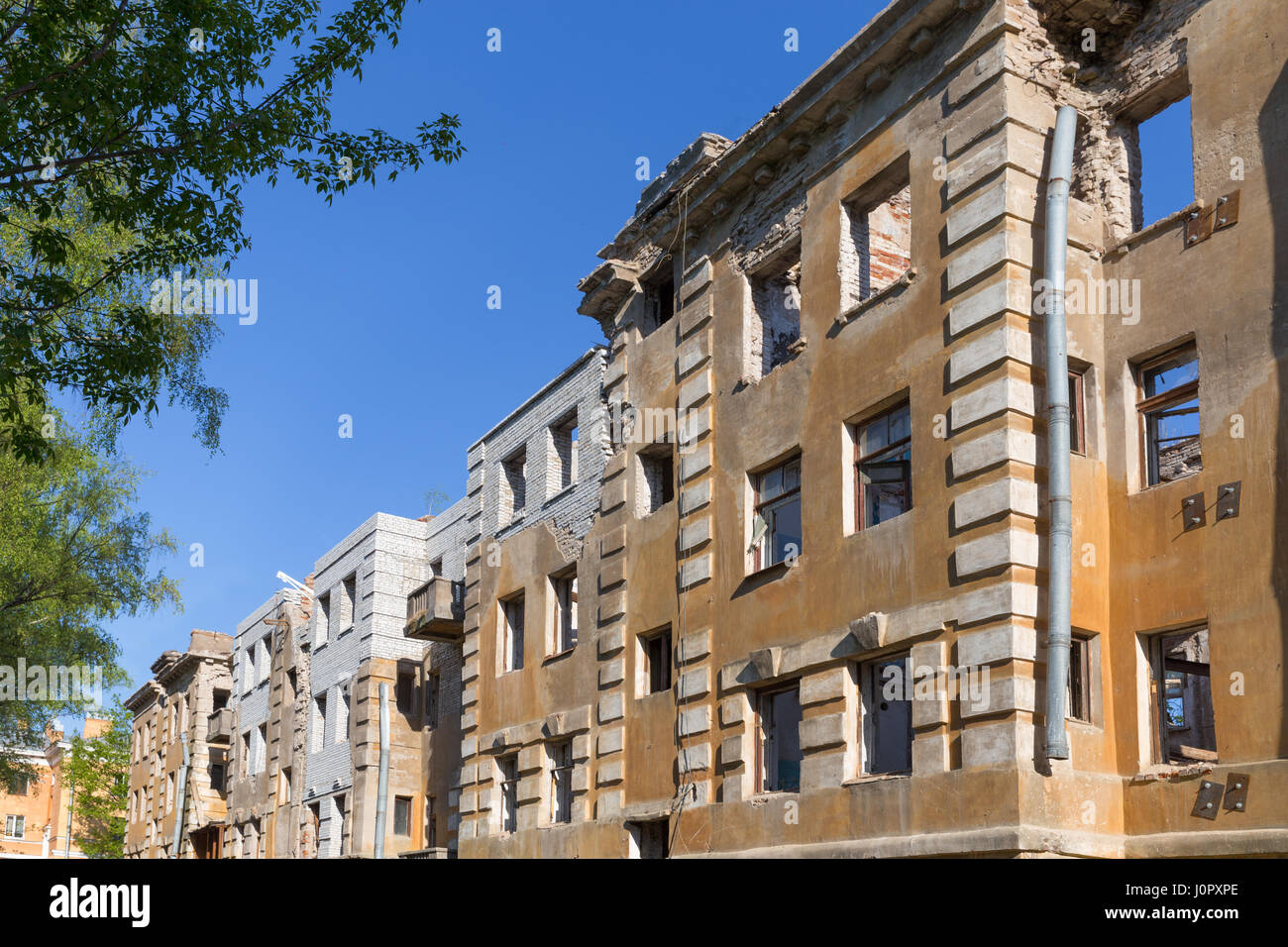 Abandoned building - broken tenement apartment house in daylight Stock ...