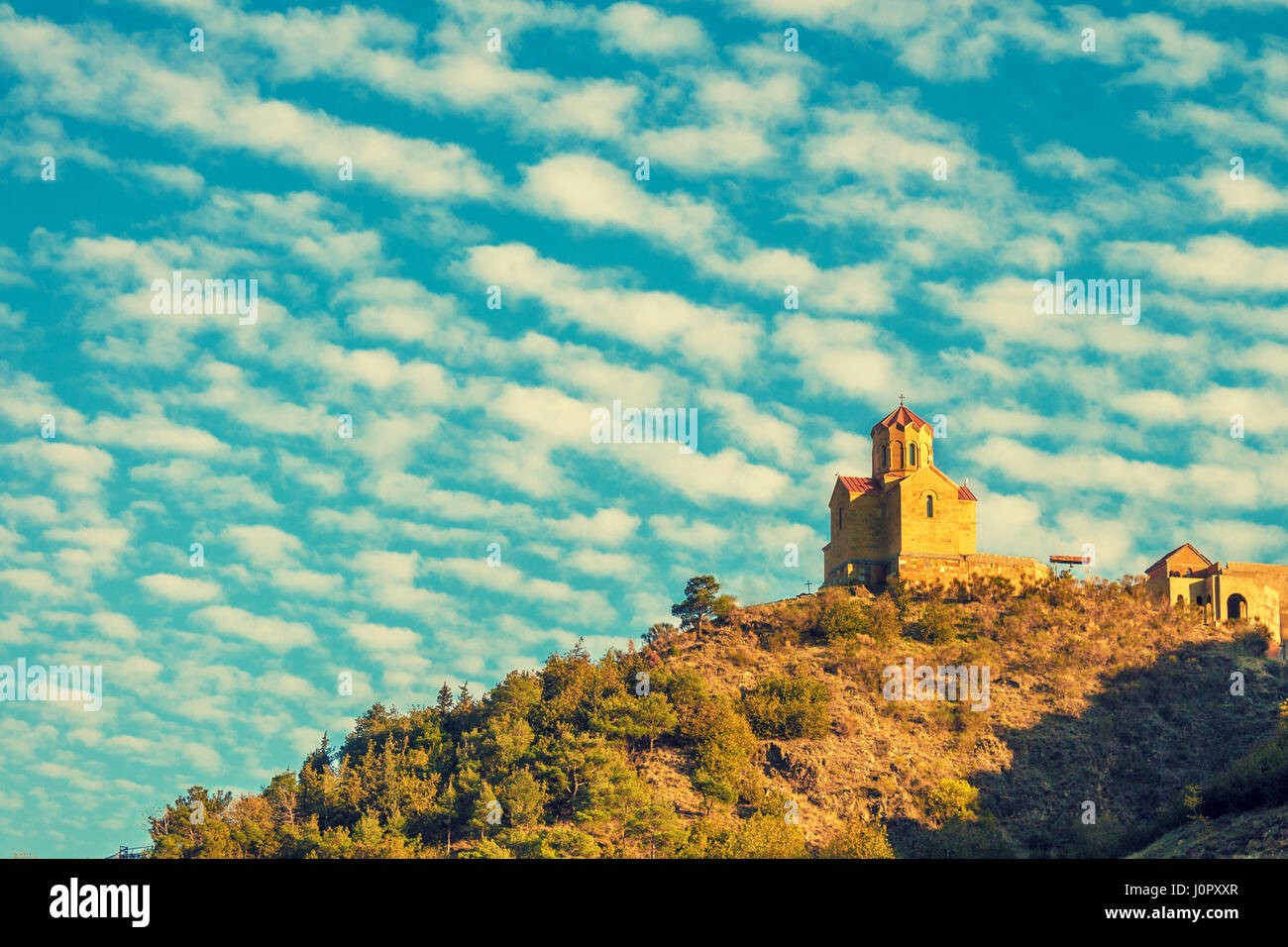 Thabori monastery on a hill with rainbow behind in Tbilisi, Georgia country Stock Photo