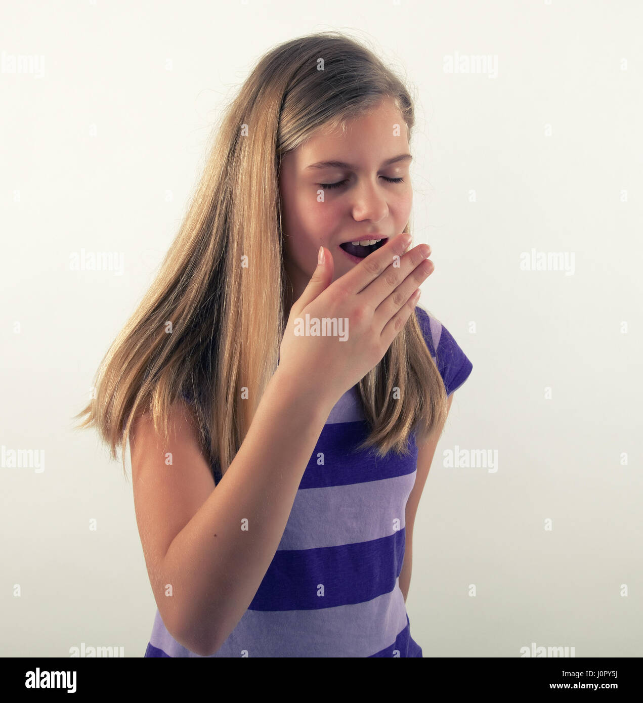 beautiful young tired girl yawning Stock Photo