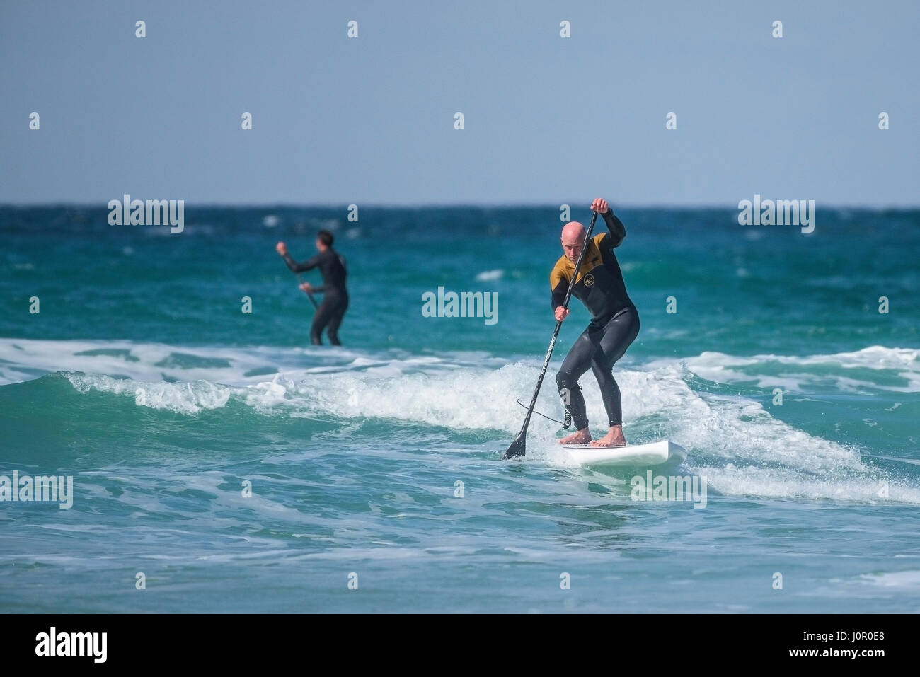 UK Paddle boarding Paddle boarder Surf Wave Sea Spray Watersport Physical activity Skill Spectacular action Leisure activity Lifestyle Stock Photo