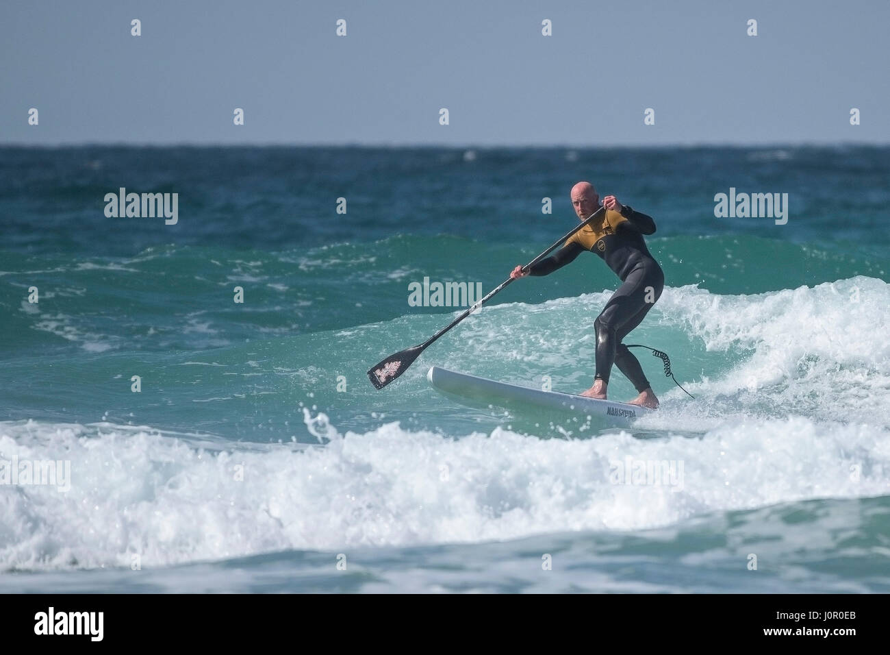 UK Paddle boarding Paddle boarder Surf Wave Sea Spray Watersport Physical activity Skill Spectacular action Leisure activity Lifestyle Stock Photo