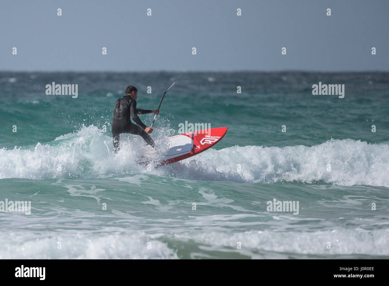 UK Paddle boarding Paddle boarder Surf Wave Sea Spray Watersport Physical activity Skill Spectacular action Leisure activity Lifestyle Stock Photo
