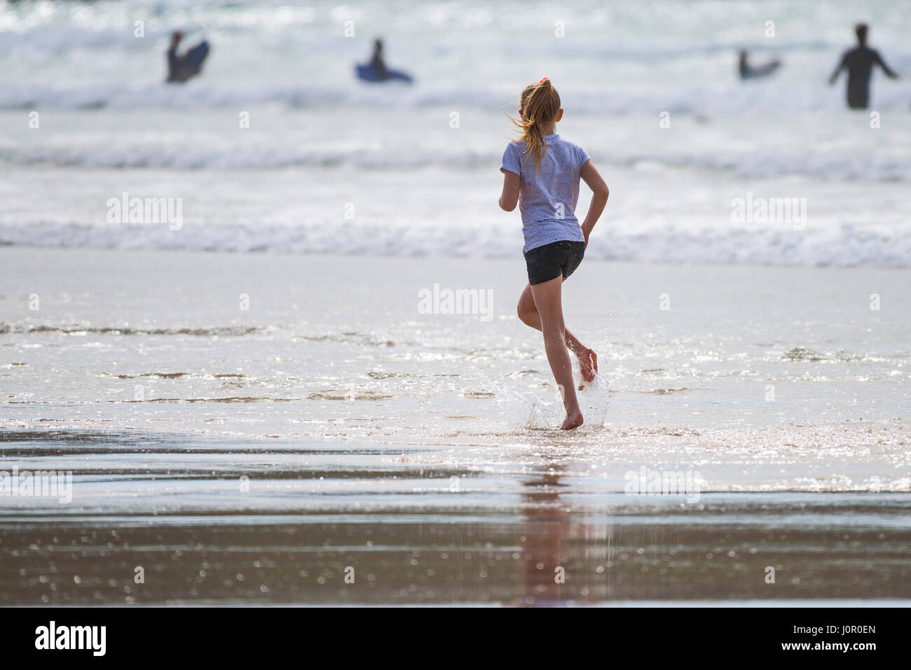 Young Girl Running Shoreline Fistral Beach Energetic; Holiday; Vacation Leisure Cornwall Seaside Newquay Having Fun Tourism Stock Photo
