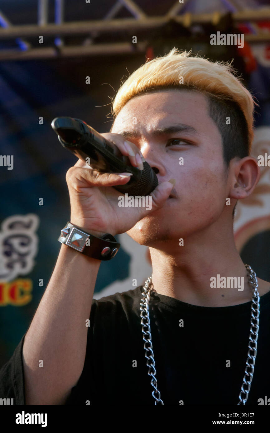 A Cambodian man is singing a song at an annual Khmer New Year celebration at a pagoda in Chork Village, Tboung Khmum Province, Cambodia. Stock Photo