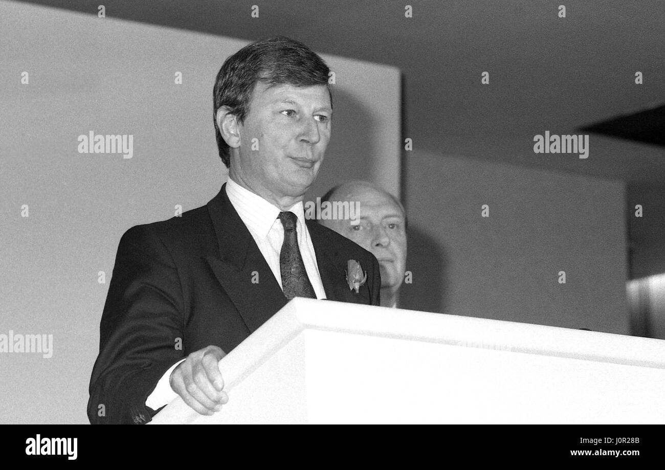Bryan Gould, Shadow Secretary of State for the Environment and Labour party Member of Parliament for Dagenham, speaks at a policy launch press conference in London, England on May 24, 1990. Neil Kinnock, Party Leader, is in the background. Stock Photo