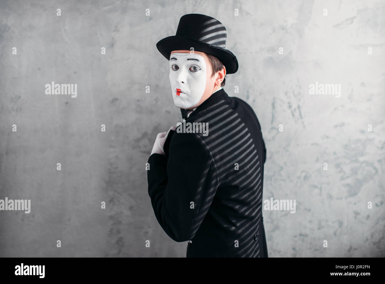 Male comedy artist posing, pantomime with white makeup mask. Circus ...