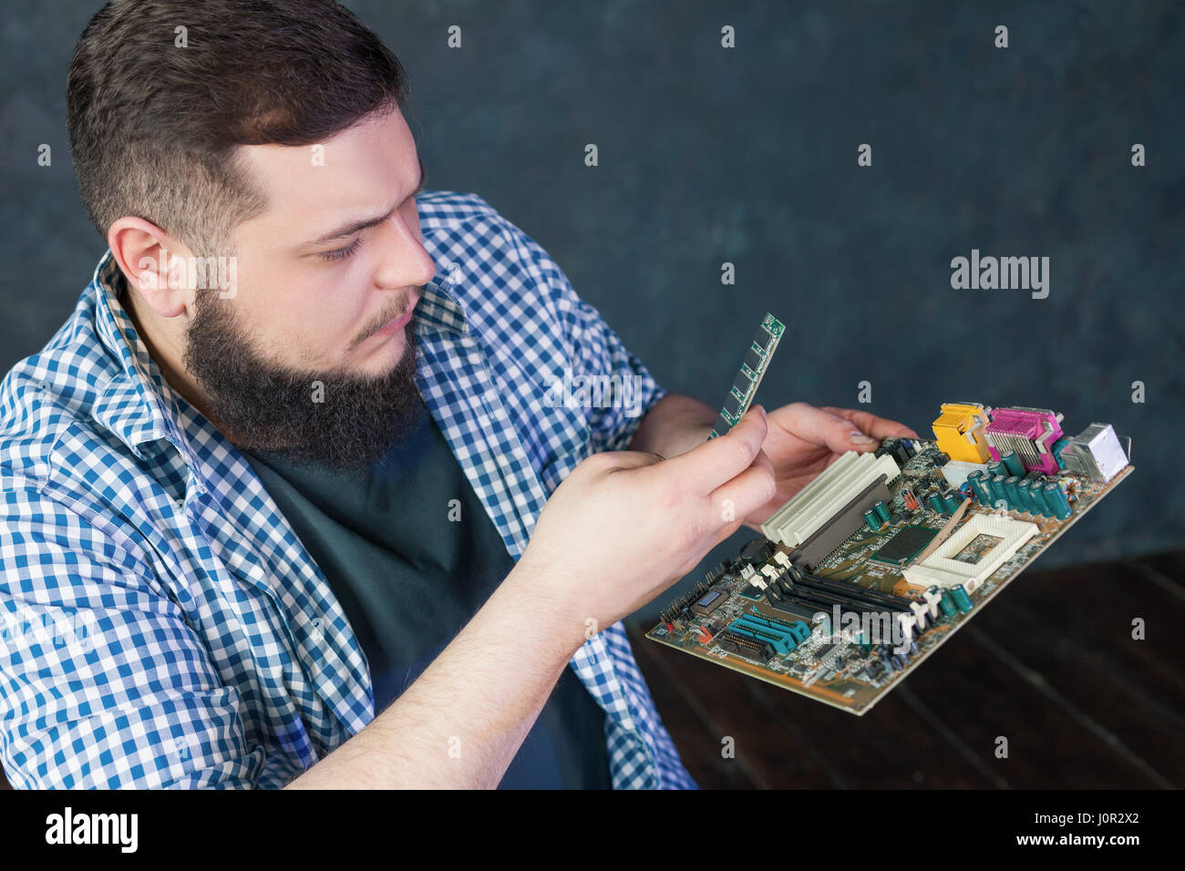 Service engineer fixing problem with pc hardware. Computer electronic ...