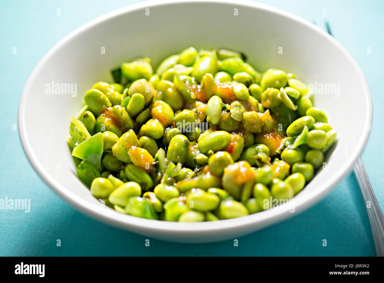 Edamame soya beans with peas and lemongrass with chilli dressing Stock