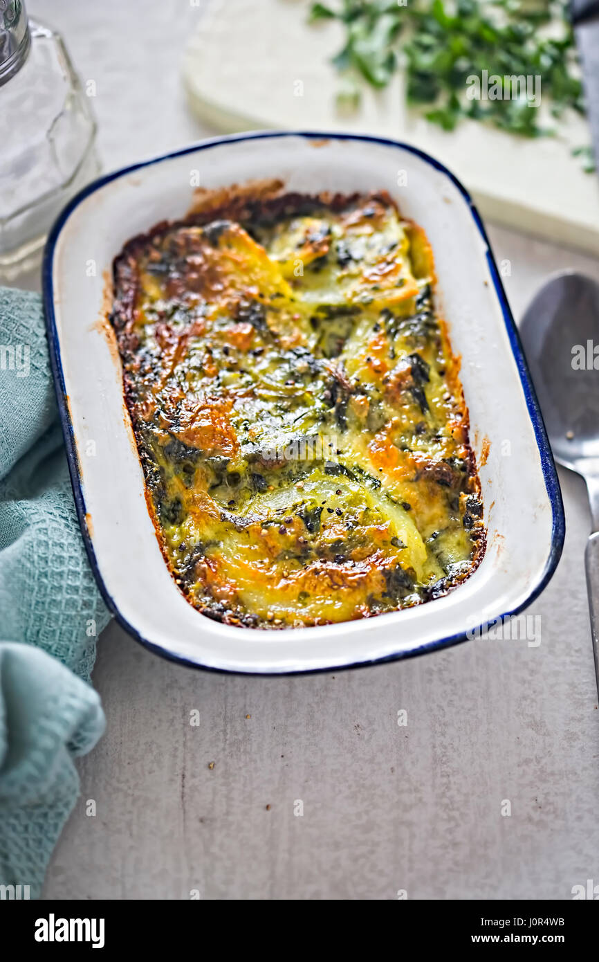 Potato and spinach gratin in creamy garlic sauce Stock Photo Alamy