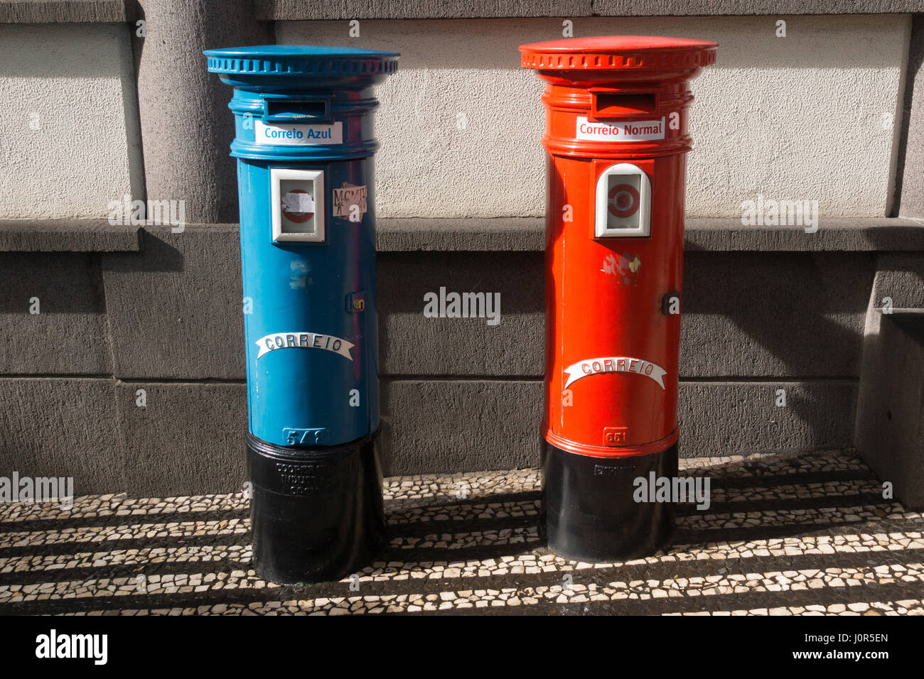 A first class (Correio Azul) and second class (Correio Normal) pillar box outside the Portugal Telecom building in Funchal, Madeira Stock Photo