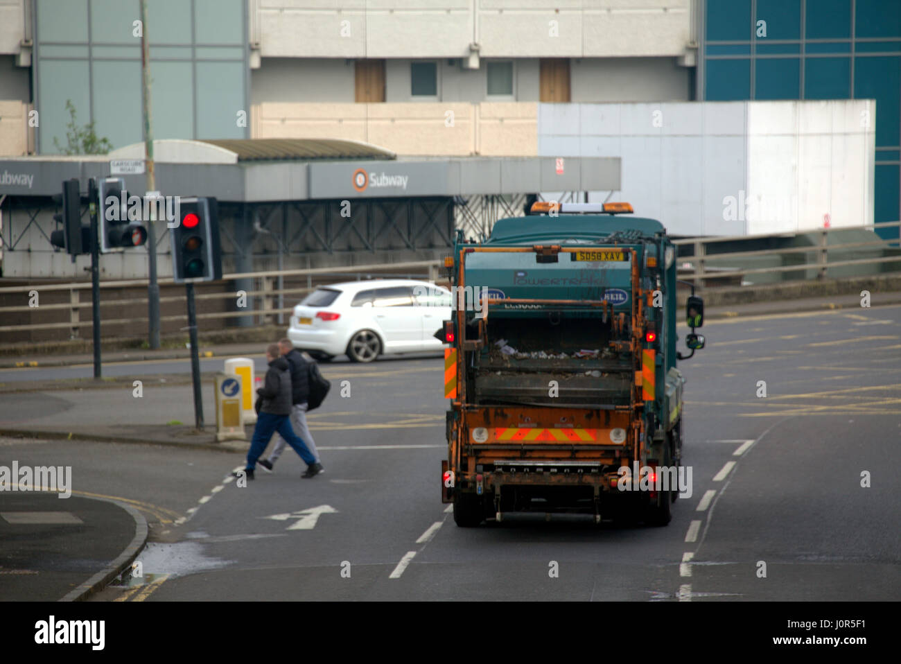 bin lorry rear view back  on the street showing rubbish disposal entrance and mechanism garbage or litter Stock Photo
