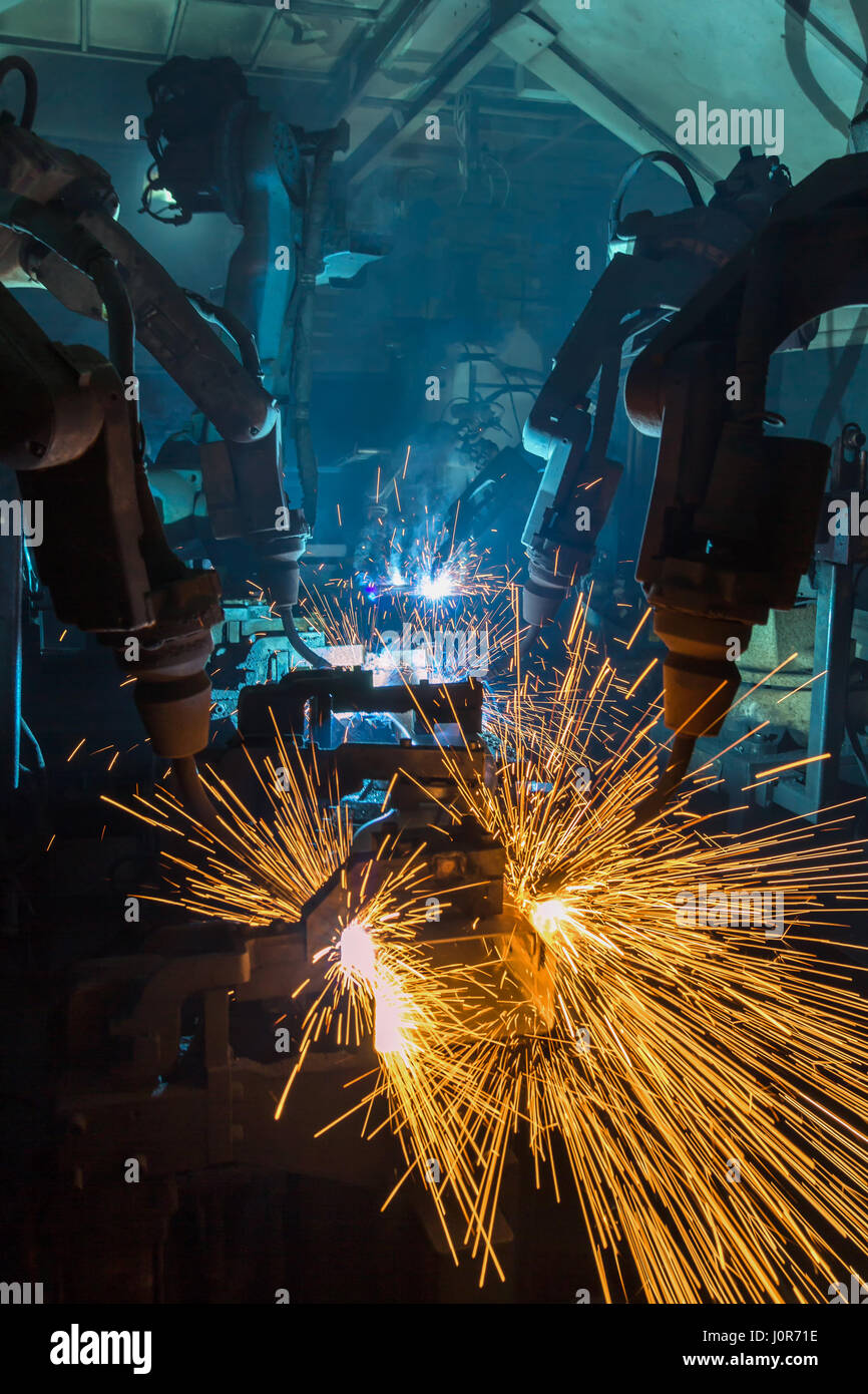 Robots welding in a car factory. Welding car body Stock Photo - Alamy