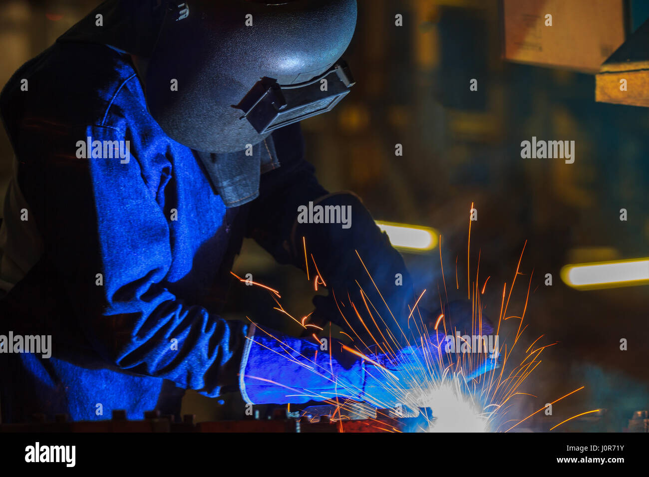 Industrial Worker at the factory welding metal ,closeup Stock Photo