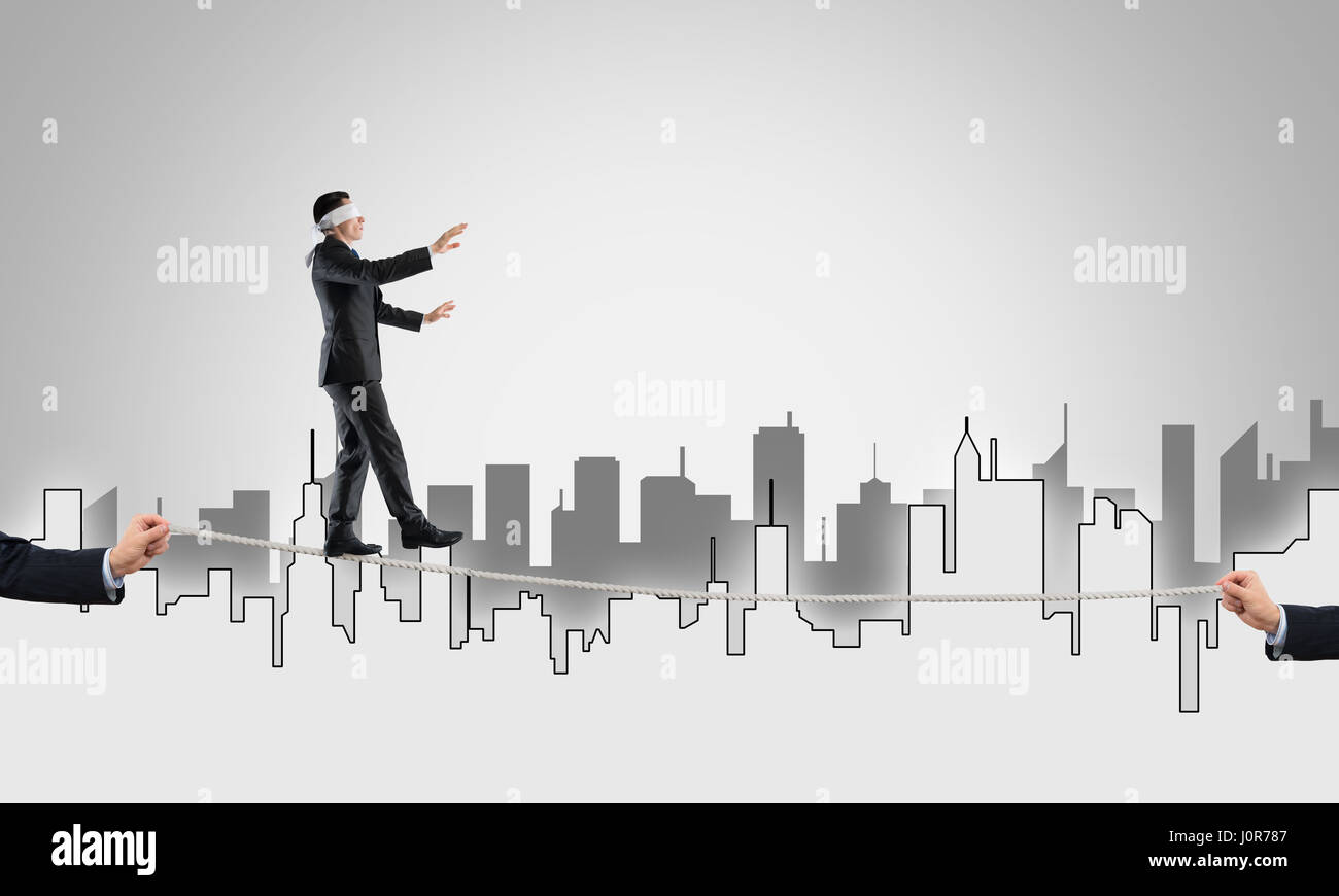 Business concept of risk support and assistance with man balancing on ...