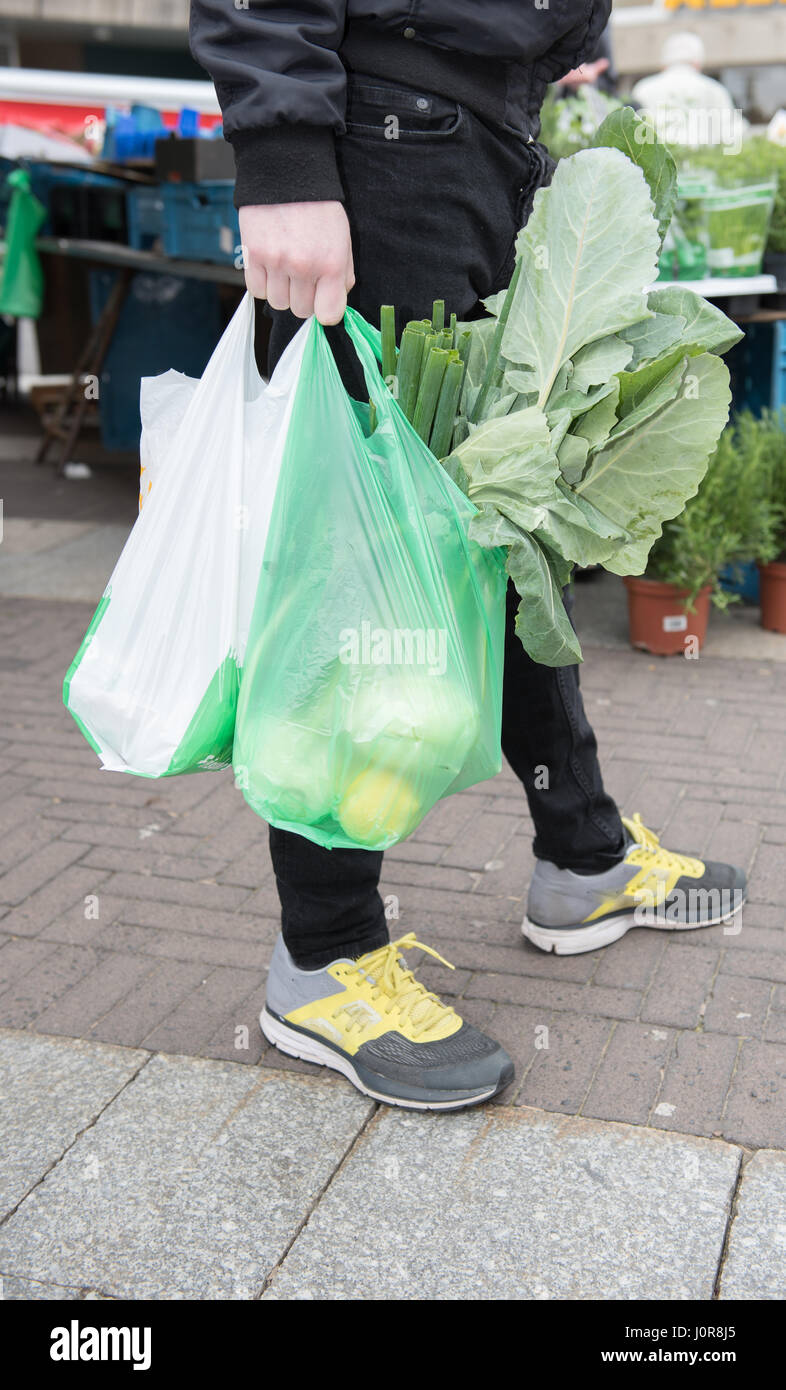 Young man carries his purchase in plastic bags of the weekly market Stock  Photo - Alamy