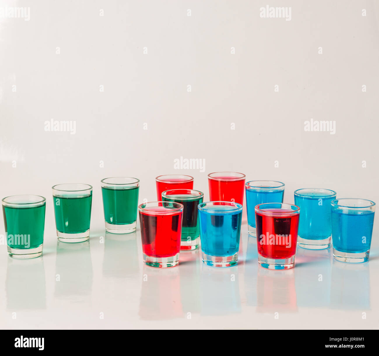 Glasses with blue, green and red kamikaze, glamorous drinks, mixed
