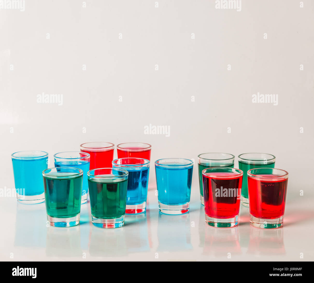 Glasses with blue, green and red kamikaze, glamorous drinks, mixed