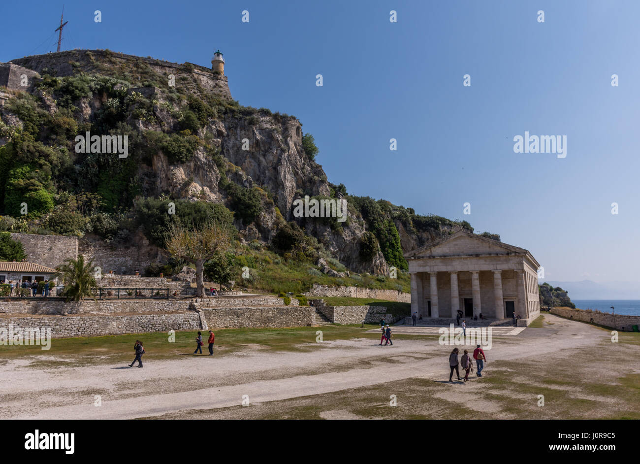 Corfu, Greece - April 15, 2017: people taking a stroll outside the Church of St. George inside the old fortress of Corfu. Stock Photo