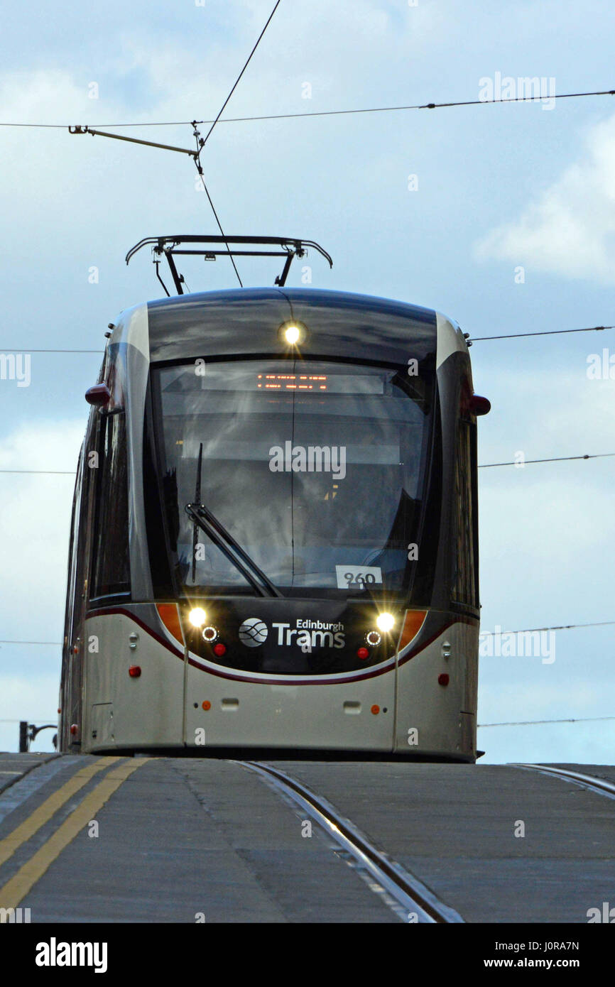 A tram crests a rise in Edinburgh city centre in the final stages of ...