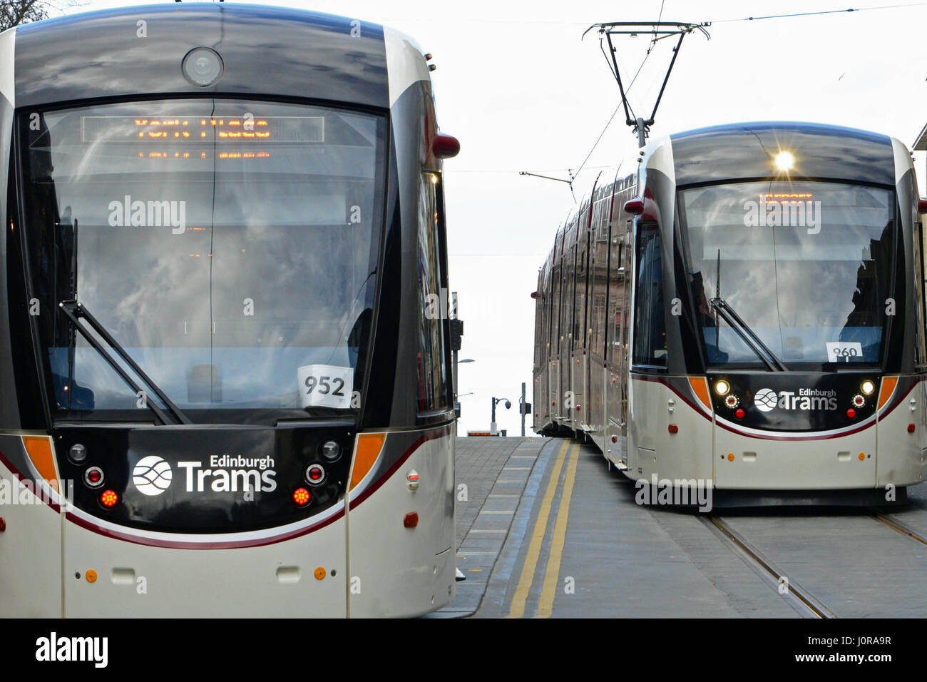 Two trams pass each other in Edinburgh city centre in the final stages of testing for the capital's new tramway system Stock Photo