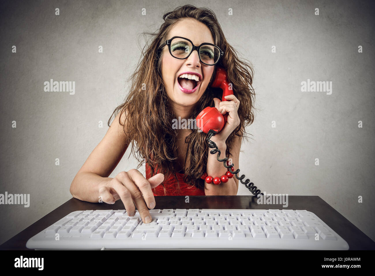 Brunette woman talking on retro phone Stock Photo