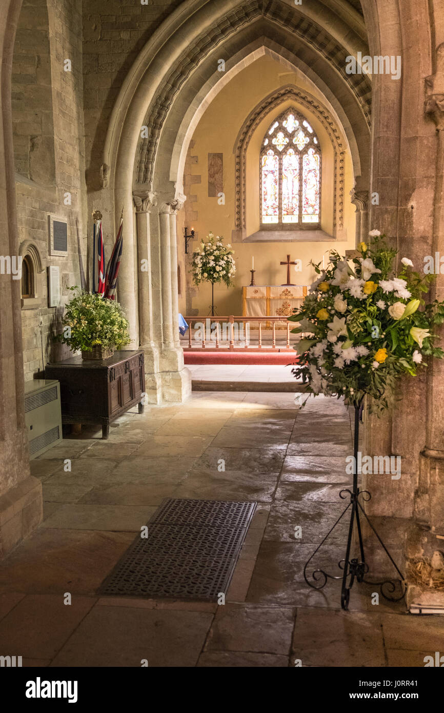 A Cotswold church prepares for Easter with floral displays of white lilies etc. Stock Photo