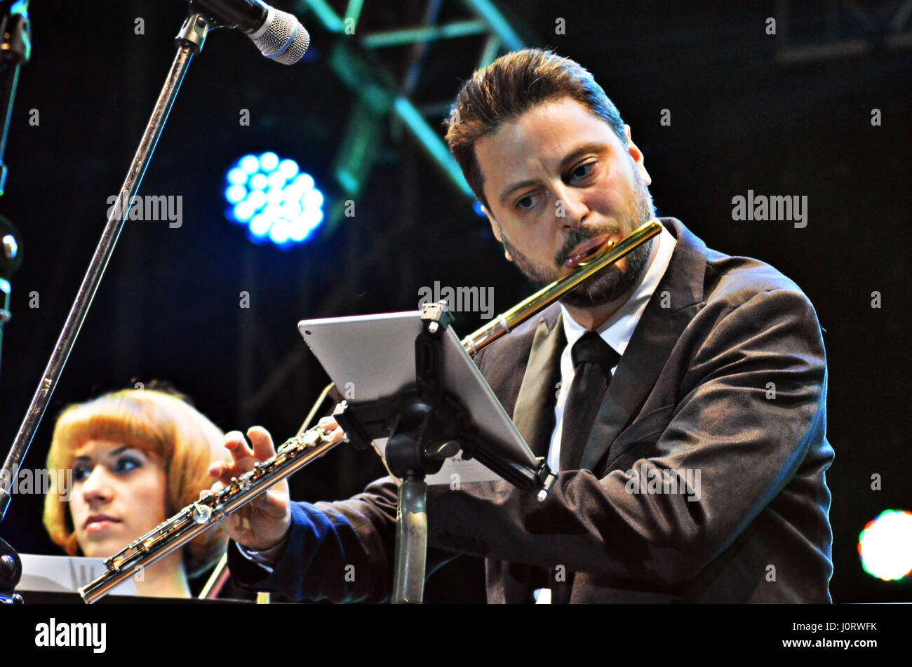 Bucharest, Romania. 15th April, 2017. Flautist Matei Ioachimescu plays with the all-female string quartet Passione on an open air stage at the city's largest Easter Fair. Credit: Douglas MacKenzie/Alamy Live News Stock Photo