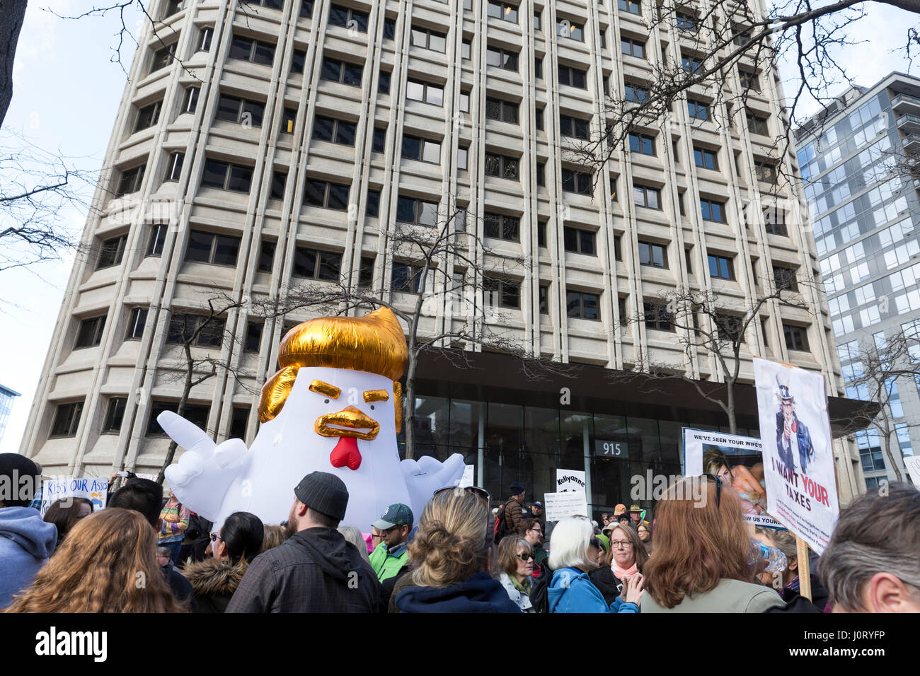 Seattle, Washington, USA. 15th April, 2017. "Chicken Don" statue appears at the rally at the Henry M. Jackson Federal Building. Hundreds of protestors attended Tax March Seattle, a rally and sister march to the National Tax March taking place in over 180 communities across the U.S. Activists are demanding that President Trump release his tax returns and reveal his business dealings, financial ties, and any potential conflicts of interests. Credit: Paul Gordon/Alamy Live News Stock Photo