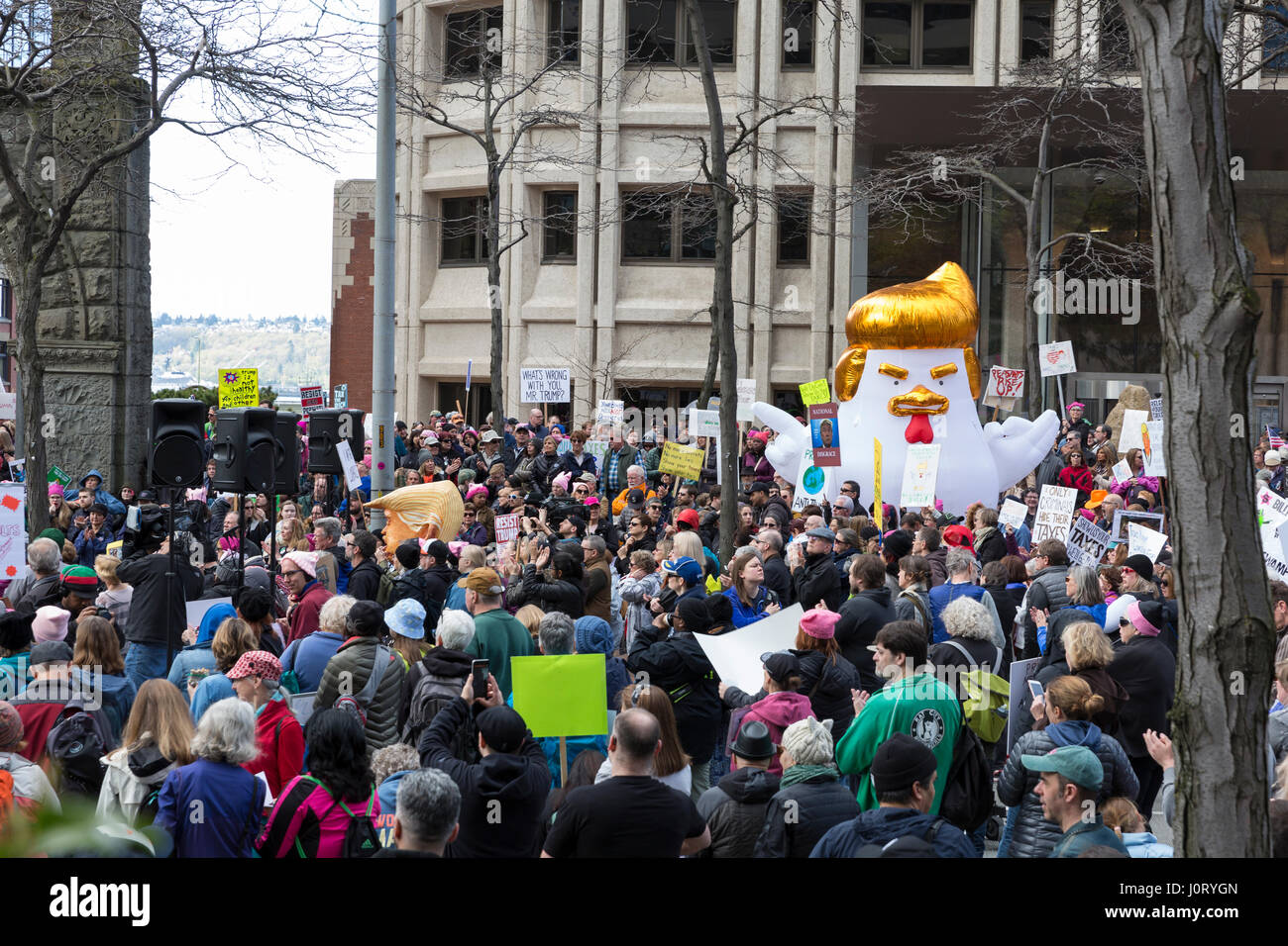 Seattle, Washington, USA. 15th April, 2017. "Chicken Don" statue appears at the rally at the Henry M. Jackson Federal Building. Hundreds of protestors attended Tax March Seattle, a rally and sister march to the National Tax March taking place in over 180 communities across the U.S. Activists are demanding that President Trump release his tax returns and reveal his business dealings, financial ties, and any potential conflicts of interests. Credit: Paul Gordon/Alamy Live News Stock Photo