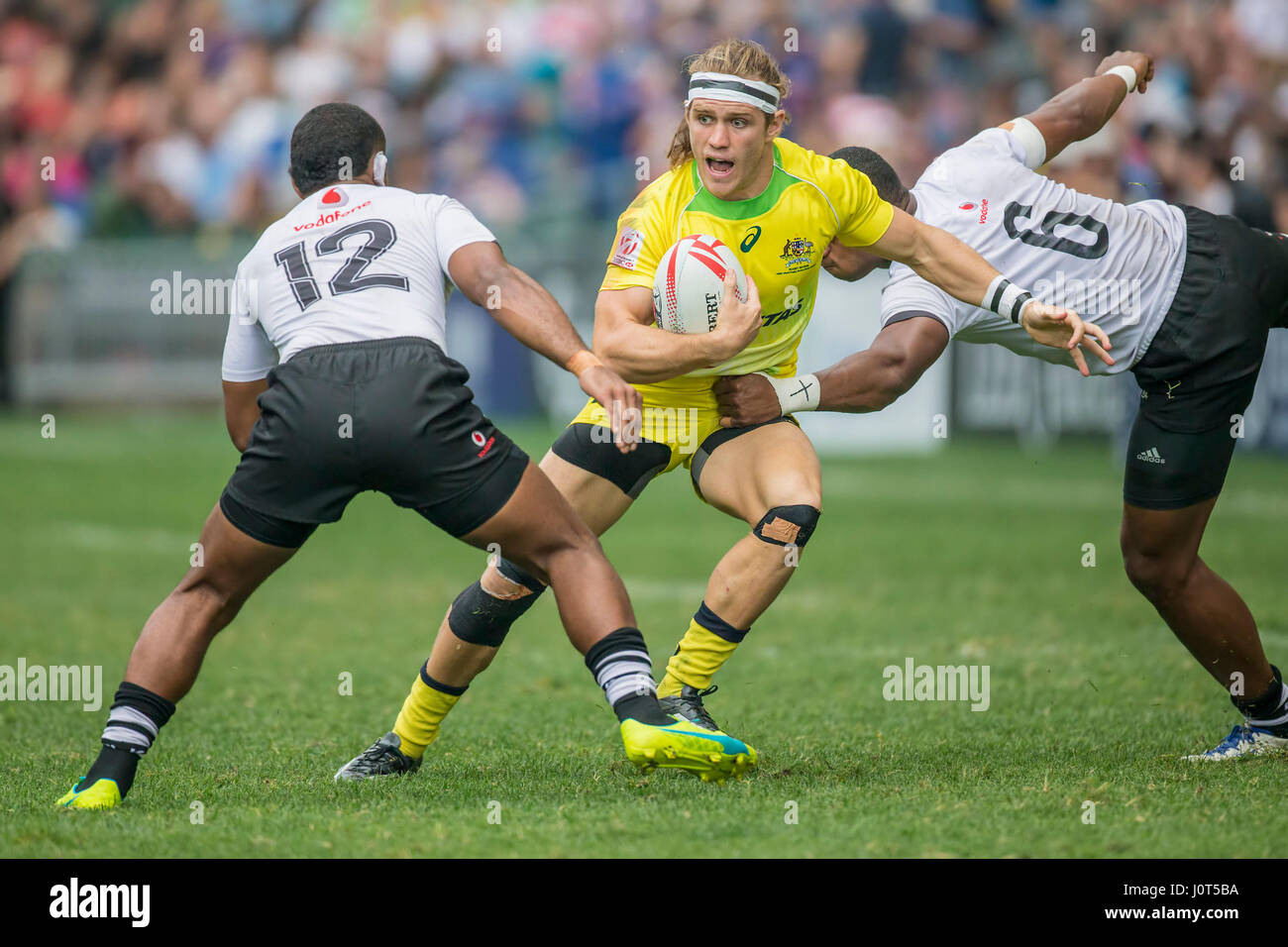 Fiji's Tom Lucas (Australia, 10) in action against Vatemo Ravouvou (Fiji, 12) and Mesulame Kunavula (Fiji, 6) at the Rugby Sevens tournament match between Fiji and Australia in Hong Kong, China from 09 until 09 April 2017.      - NO WIRE SERVICE- Photo: Jürgen Keßler/dpa Stock Photo