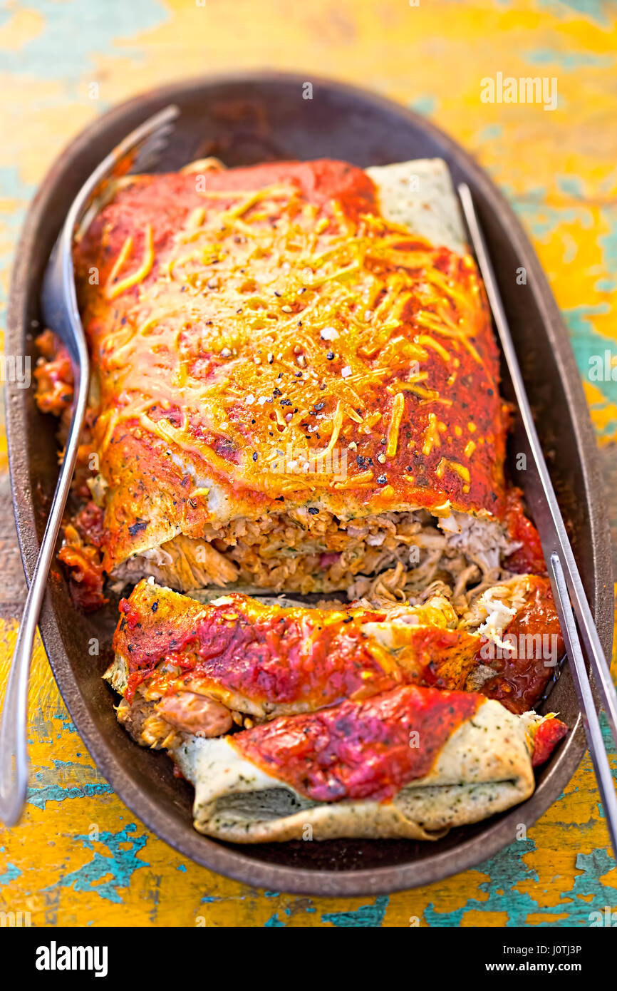 Chipotle chicken burrito in tomato sauce with cheese Stock Photo - Alamy