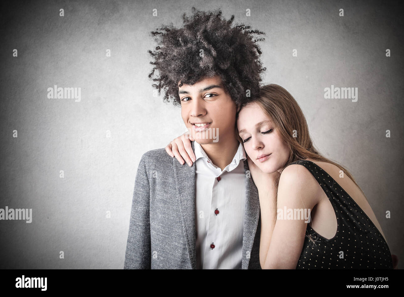 Woman hugging her boyfriend Stock Photo - Alamy